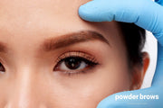 Hand an a female face during the pmu procedure.